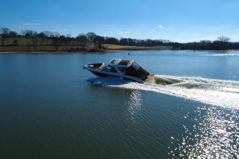  Yacht Photos Pics 2022 Sea Ray SLX 400 cruising on a serene lake under a clear blue sky.