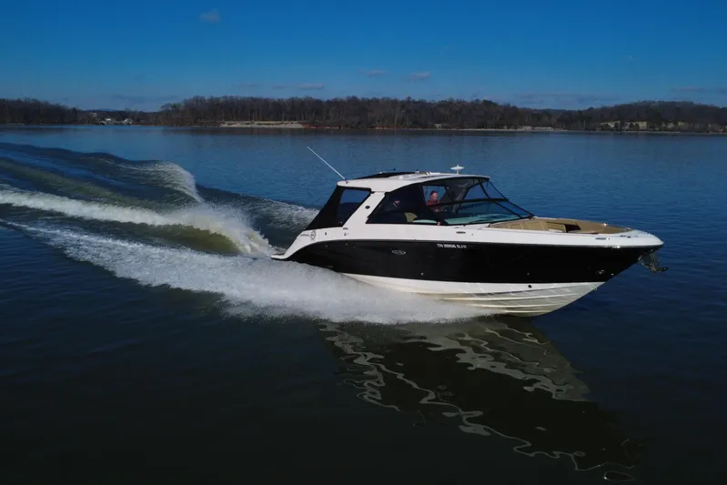  Yacht Photos Pics 2022 Sea Ray SLX 400 cruising on a calm lake under a clear blue sky.