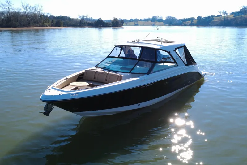  Yacht Photos Pics 2022 Sea Ray SLX 400 boat on a calm lake under clear skies.
