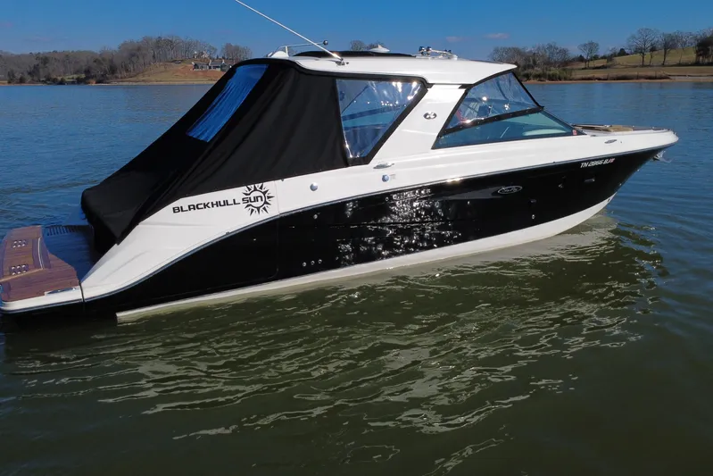  Yacht Photos Pics 2022 Sea Ray SLX 400 boat on calm water, featuring sleek black and white design.