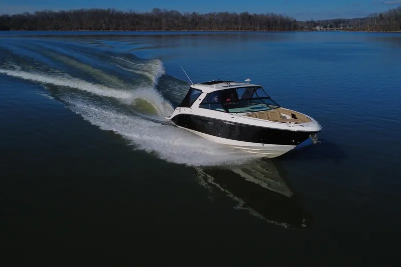  Yacht Photos Pics 2022 Sea Ray SLX 400 cruising on a calm lake, creating a smooth wake.