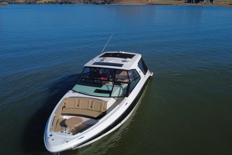  Yacht Photos Pics 2022 Sea Ray SLX 400 luxury boat cruising on a calm lake.