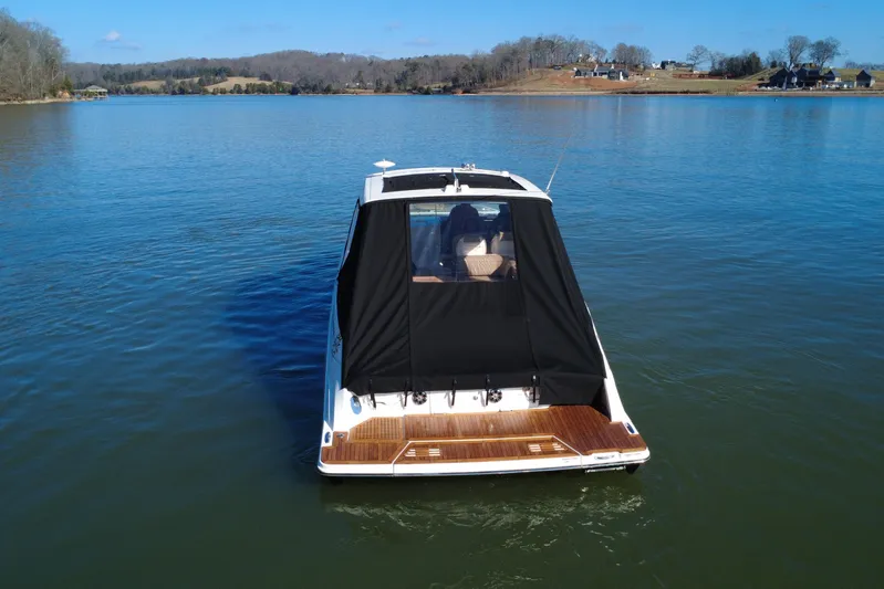  Yacht Photos Pics 2022 Sea Ray SLX 400 boat on a calm lake with scenic background.