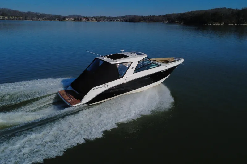  Yacht Photos Pics 2022 Sea Ray SLX 400 cruising on a calm lake under clear skies.