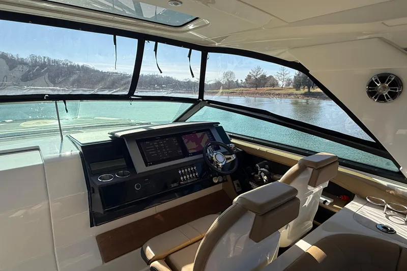  Yacht Photos Pics Interior view of 2022 Sea Ray SLX 400 boat cockpit with modern controls and scenic water view.
