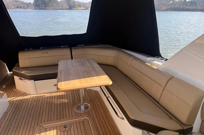  Yacht Photos Pics Luxurious seating area on 2022 Sea Ray SLX 400 boat with wooden table.