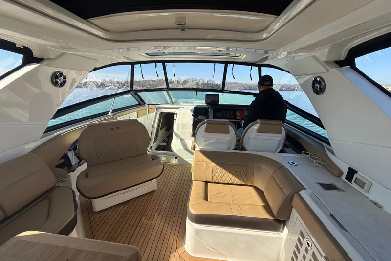  Yacht Photos Pics Luxurious 2022 Sea Ray SLX 400 boat interior with spacious seating and modern helm.