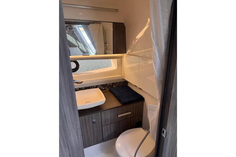 Yacht Photos Pics 2022 Sea Ray SLX 400 bathroom interior with modern sink and cabinetry.
