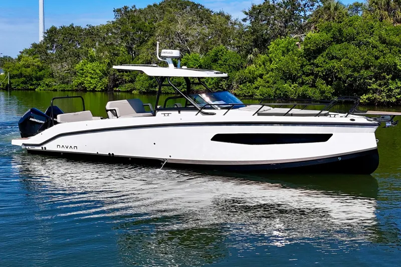  Yacht Photos Pics 2026 Navan S30 boat cruising on a calm river with lush greenery.