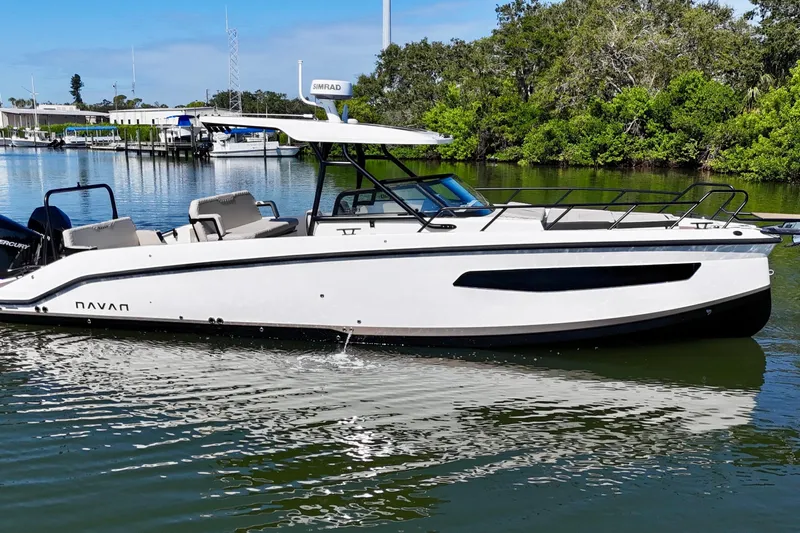  Yacht Photos Pics 2026 Navan S30 boat cruising on a calm river with lush greenery.