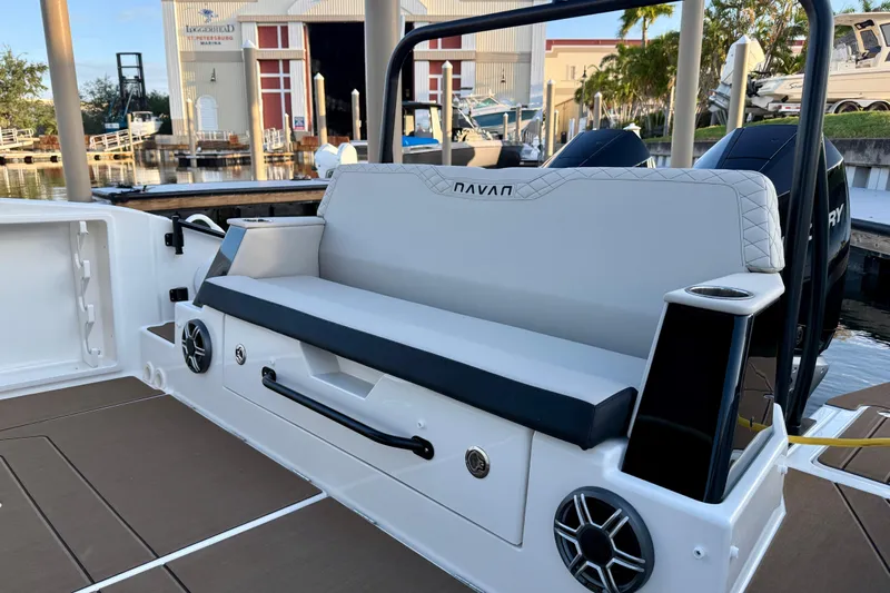  Yacht Photos Pics 2026 Navan S30 boat interior with cushioned seating and built-in speakers at a marina.