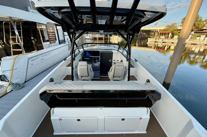  Yacht Photos Pics 2026 Navan S30 boat interior with modern seating and sleek design at a marina.