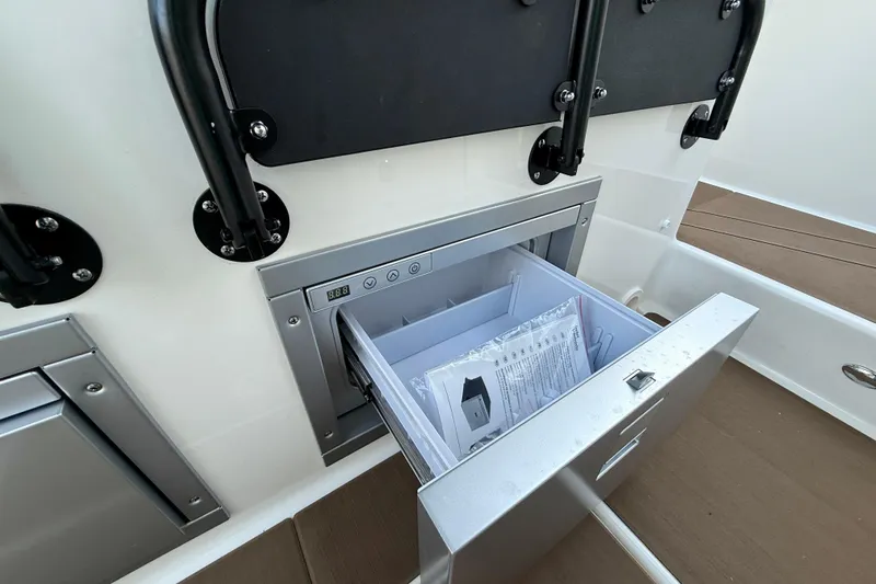  Yacht Photos Pics Open storage compartment in 2026 Navan S30 boat, featuring a digital control panel.