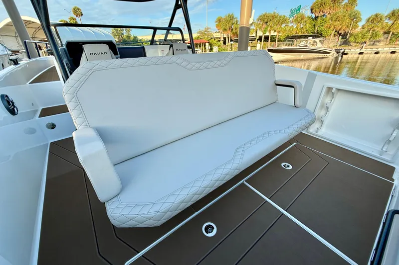  Yacht Photos Pics 2026 Navan S30 boat interior with white cushioned seating and brown flooring.