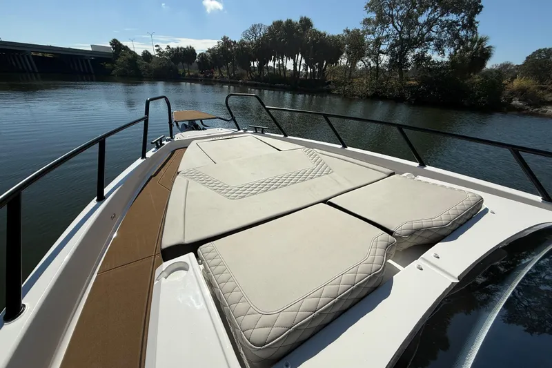  Yacht Photos Pics Luxurious Navan S30 boat deck with cushioned seating, 2026 model, on a serene river.