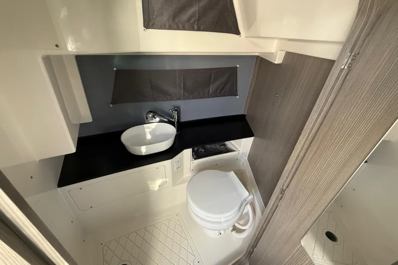  Yacht Photos Pics Modern bathroom in 2026 Navan S30, featuring sleek sink and compact toilet design.