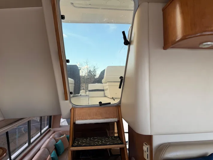  Yacht Photos Pics Interior view of 2003 Meridian 490 Pilothouse yacht with stairs leading to upper deck.