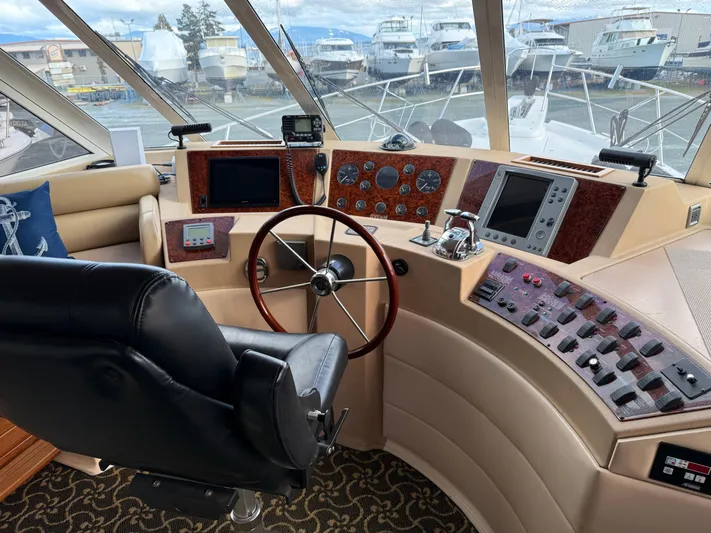  Yacht Photos Pics 2003 Meridian 490 Pilothouse interior with steering wheel, control panels, and navigation equipment.