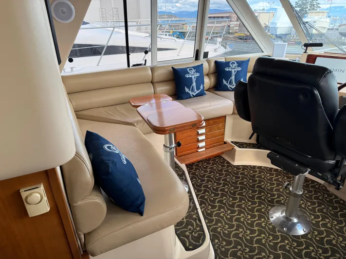  Yacht Photos Pics Interior of 2003 Meridian 490 Pilothouse with seating, nautical pillows, and helm chair.
