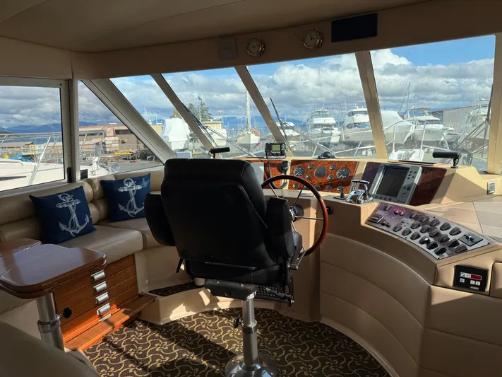  Yacht Photos Pics Pilothouse interior of 2003 Meridian 490 yacht with helm, seating, and nautical decor.