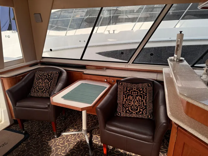  Yacht Photos Pics Interior of 2003 Meridian 490 Pilothouse with leather chairs and table, elegant design.
