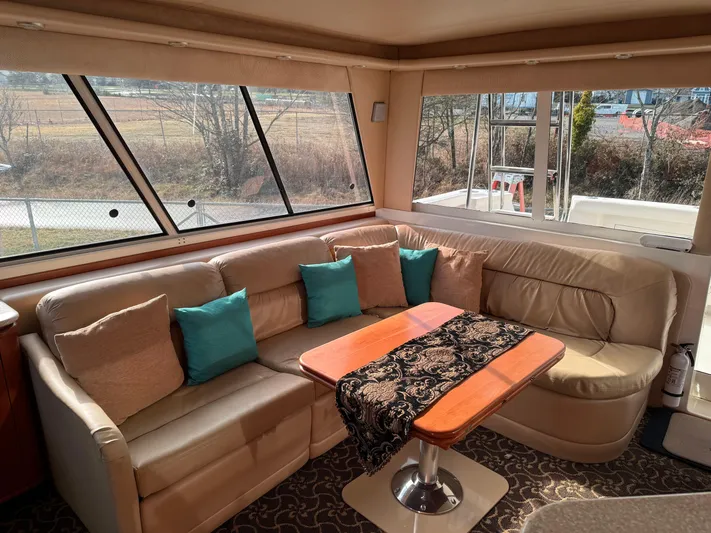  Yacht Photos Pics Luxurious interior of 2003 Meridian 490 Pilothouse with plush seating and elegant decor.