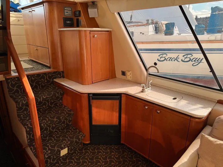  Yacht Photos Pics Interior of 2003 Meridian 490 Pilothouse yacht with wood cabinetry and compact kitchenette.
