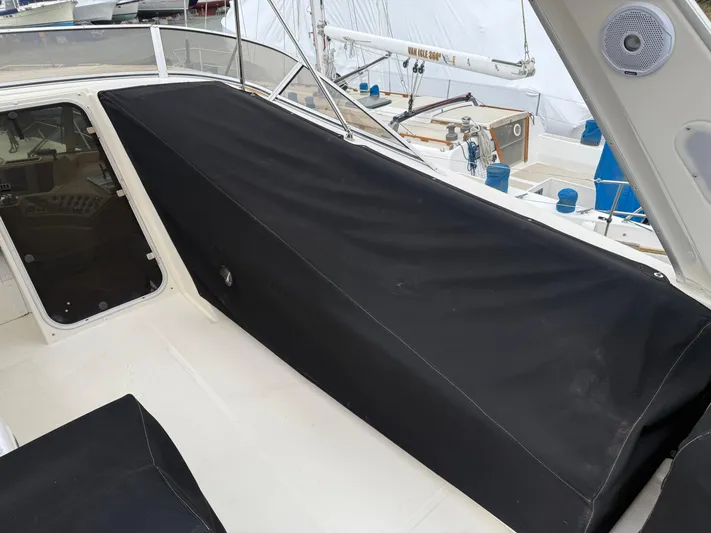  Yacht Photos Pics 2003 Meridian 490 Pilothouse boat with black cover on deck.