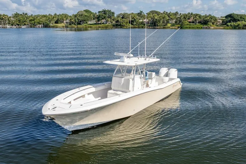  Yacht Photos Pics 2013 Invincible 36 boat on calm water with scenic background.