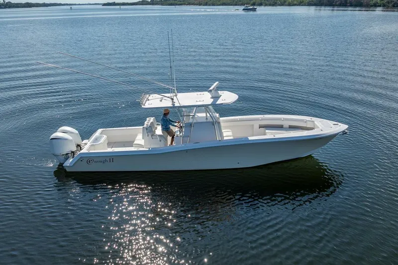  Yacht Photos Pics 2013 Invincible 36 boat on calm water, featuring dual outboard engines.