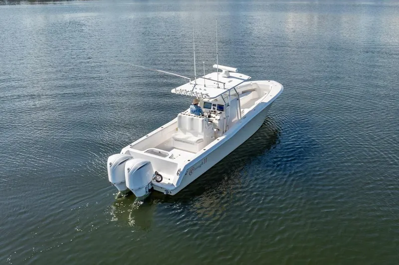  Yacht Photos Pics 2013 Invincible 36 boat on calm water, featuring dual outboard motors.