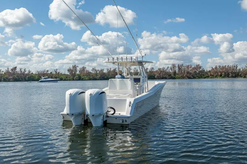  Yacht Photos Pics 2013 Invincible 36 boat on calm water under a blue sky.