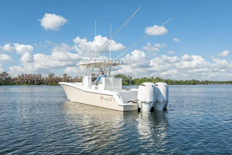  Yacht Photos Pics Invincible 36 boat from 2013 on calm water under a blue sky.