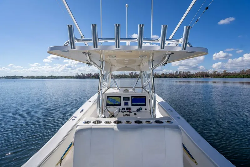  Yacht Photos Pics 2013 Invincible 36 boat on calm water, featuring a modern helm and fishing rod holders.