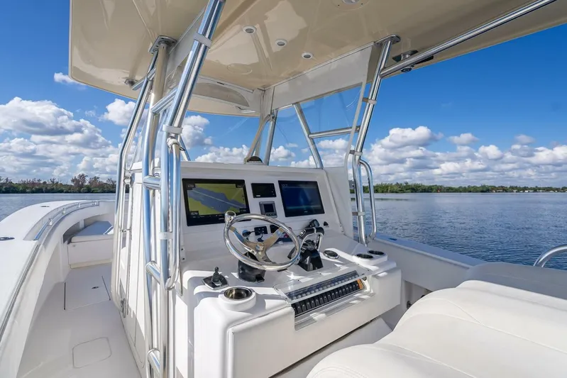  Yacht Photos Pics 2013 Invincible 36 boat cockpit with modern navigation system on a sunny day.