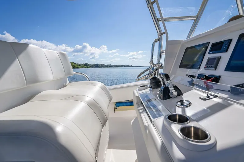  Yacht Photos Pics Interior view of 2013 Invincible 36 boat cockpit with steering and controls.