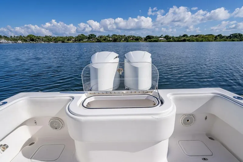  Yacht Photos Pics Invincible 36 boat deck, 2013 model, overlooking serene lake and blue sky.