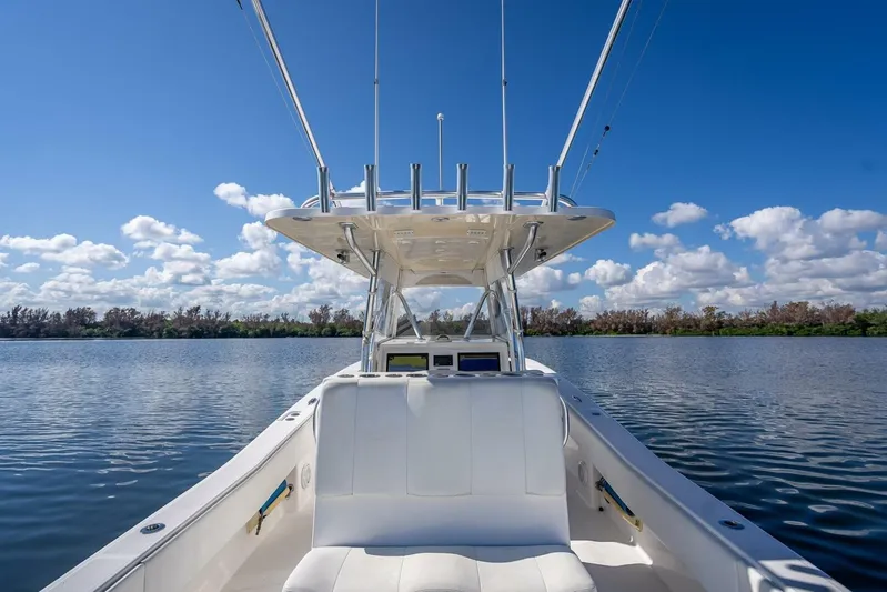  Yacht Photos Pics Invincible 36 boat, 2013 model, on calm water under a clear blue sky.