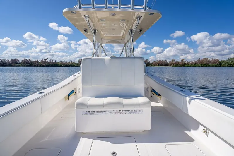  Yacht Photos Pics Invincible 36 boat interior, 2013 model, on calm water under a blue sky.