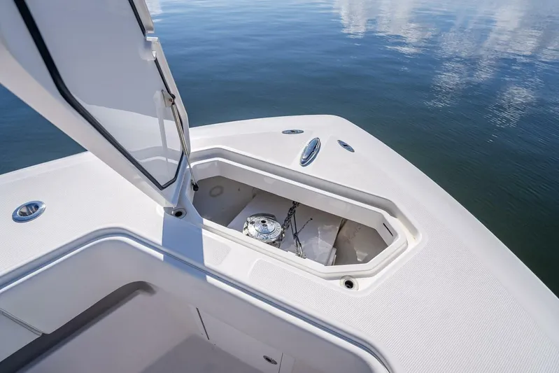  Yacht Photos Pics Open anchor compartment on 2013 Invincible 36 boat, reflecting on calm water.