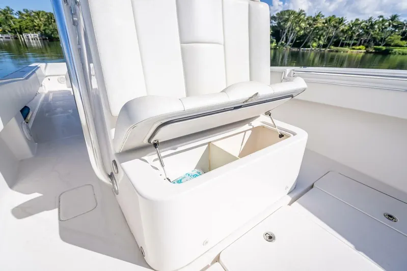  Yacht Photos Pics 2013 Invincible 36 boat with open storage compartment, white seating, and scenic water view.
