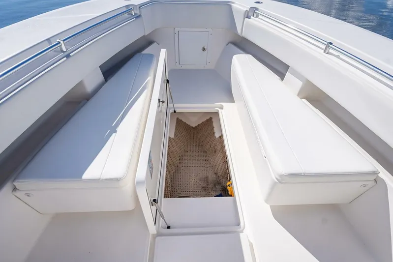  Yacht Photos Pics Invincible 36 boat interior, 2013 model, featuring white seating and storage compartment.