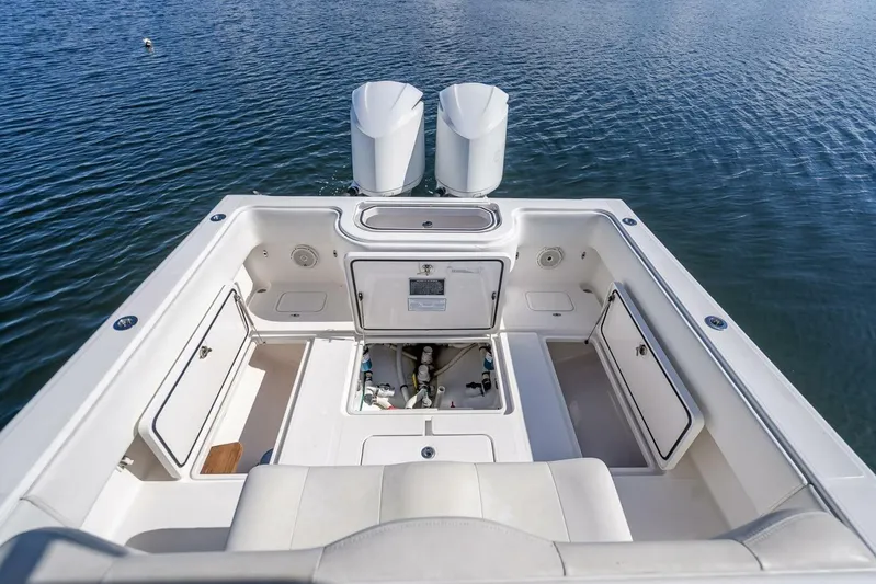  Yacht Photos Pics Invincible 36 boat, 2013 model, open storage compartments, dual engines, on calm water.