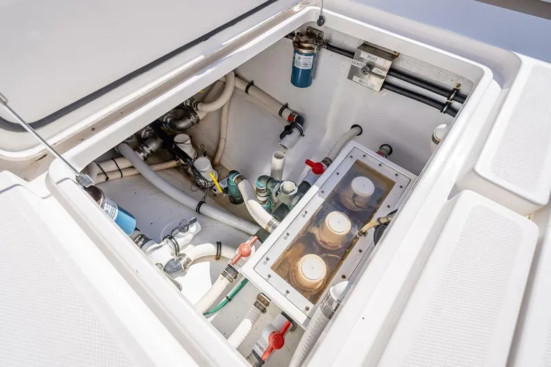  Yacht Photos Pics Engine compartment of 2013 Invincible 36 boat, showcasing pipes and filters.