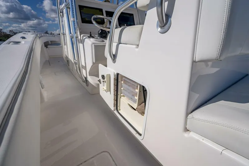  Yacht Photos Pics 2013 Invincible 36 boat interior with sleek white seating and storage compartment.