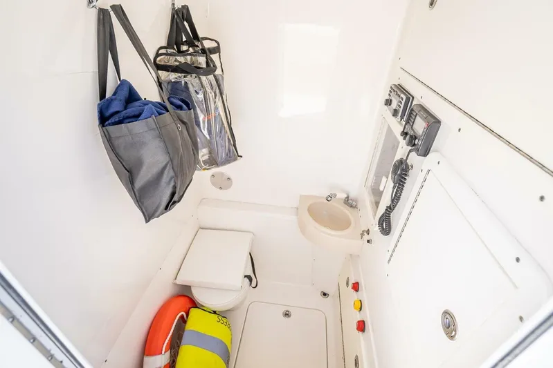  Yacht Photos Pics Compact bathroom in 2013 Invincible 36 boat with toilet, sink, and storage.