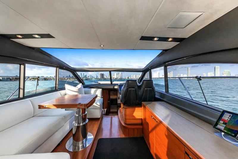 Presumed Innocent Yacht Photos Pics Luxurious interior of 2017 Princess V48 Open yacht with panoramic windows and elegant seating.