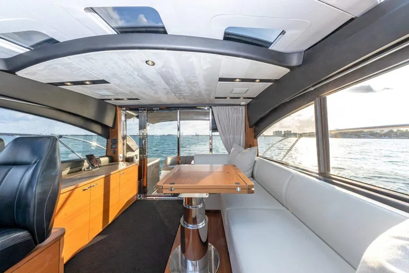 Presumed Innocent Yacht Photos Pics Interior of 2017 Princess V48 Open yacht with modern seating and ocean view.