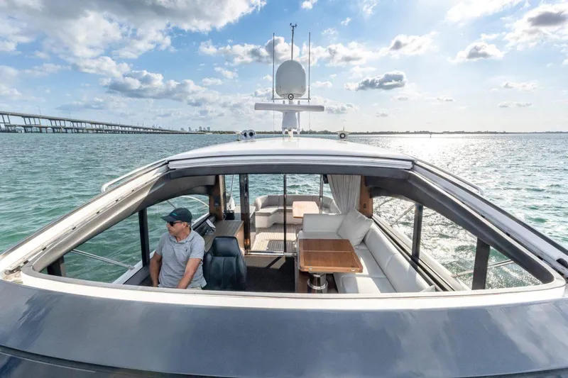 Presumed Innocent Yacht Photos Pics 2017 Princess V48 Open yacht cruising on a sunny day with bridge in background.