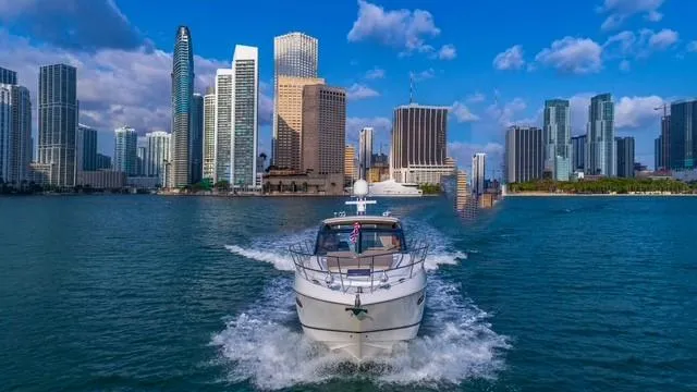 Presumed Innocent Yacht Photos Pics 2017 Princess V48 Open yacht cruising in front of a city skyline.